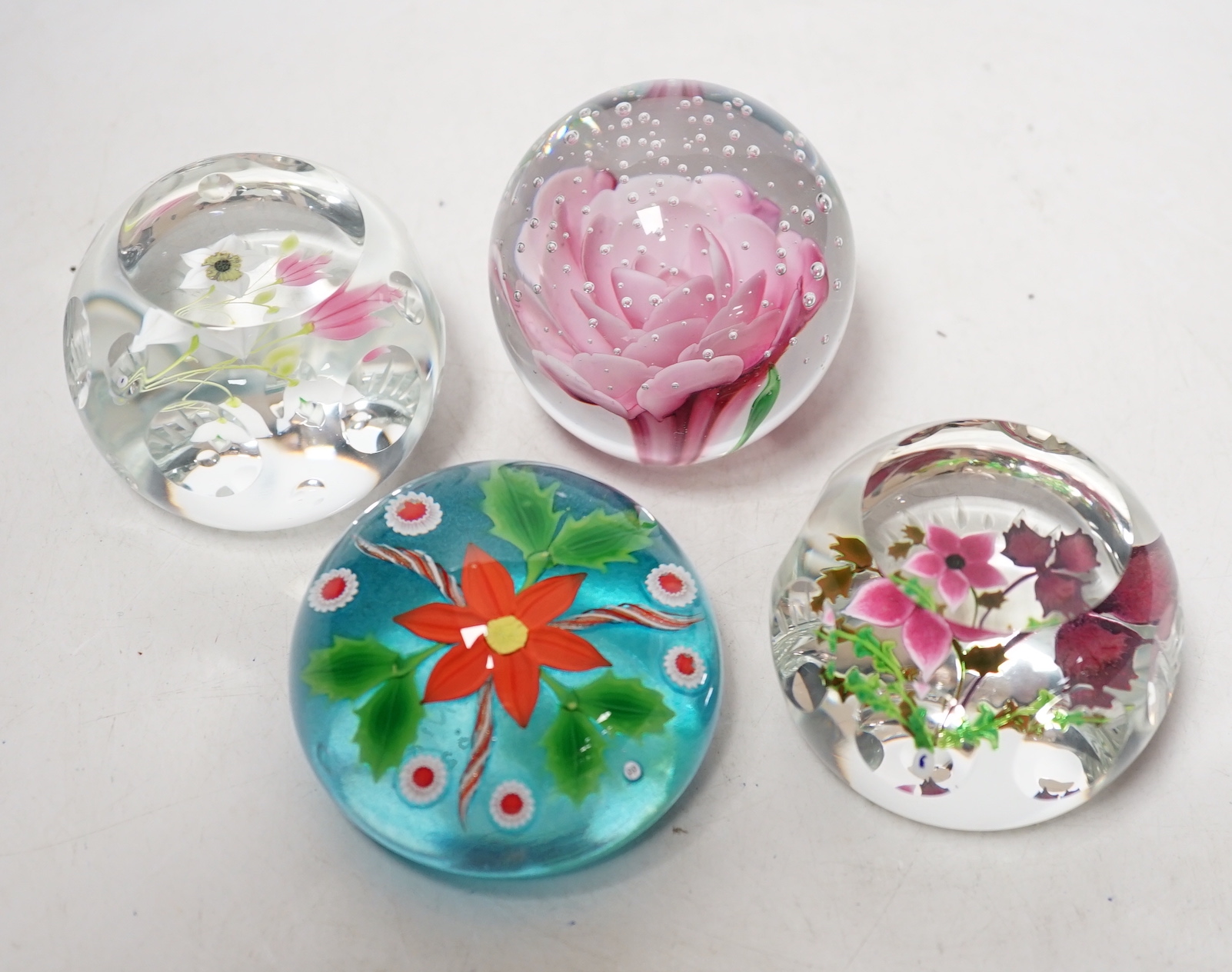 Four lampwork glass flower paperweights, Phoenix, 10/50, Caithness 199/250 and 194/250 and another, 7.5cm in diameter (4)